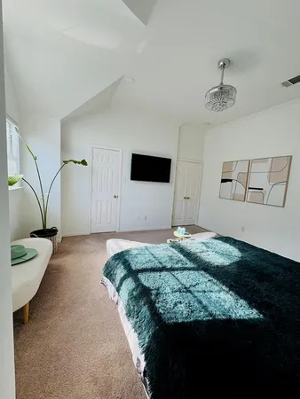 a bedroom with a bed and a flat screen tv