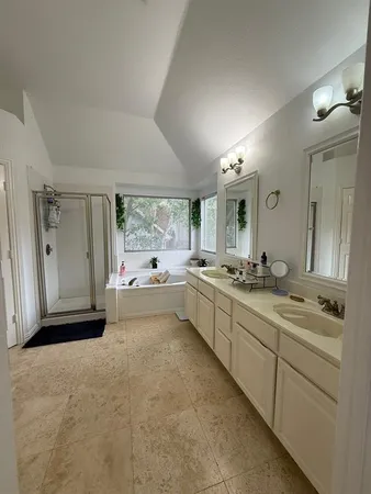 a large bathroom with a large mirror vanity and shower