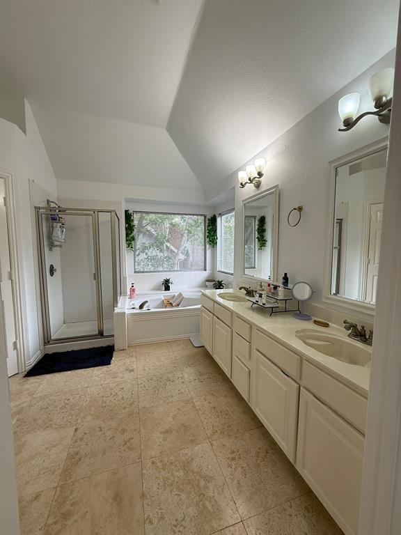 417 Moonlight Way Irving, TX 75063 - Photo 19 of 31 a large bathroom with a large mirror vanity and shower