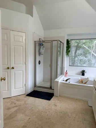 a bathroom with double vanity and a mirror