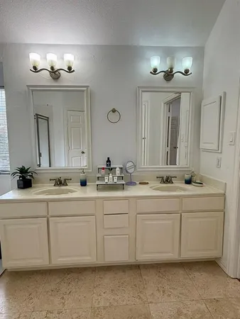a bath room with sink and mirror