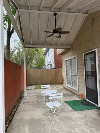 a view of backyard with wooden fence