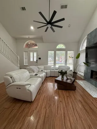 a living room with furniture fireplace and a large window