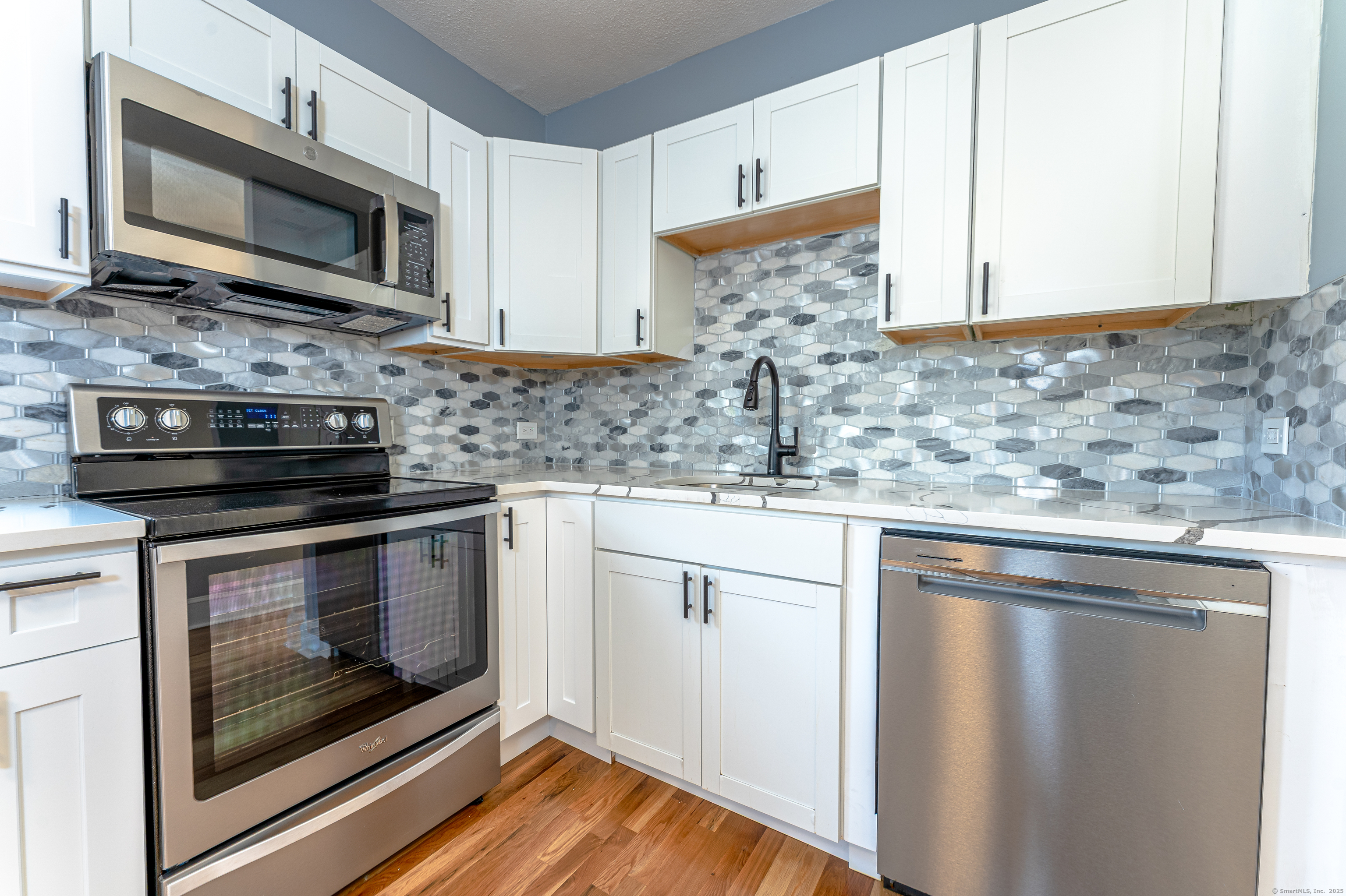 100 Ridgefield Avenue Waterbury, CT 06705 - Photo 14 of 35 a kitchen with stainless steel appliances granite countertop a stove microwave and sink