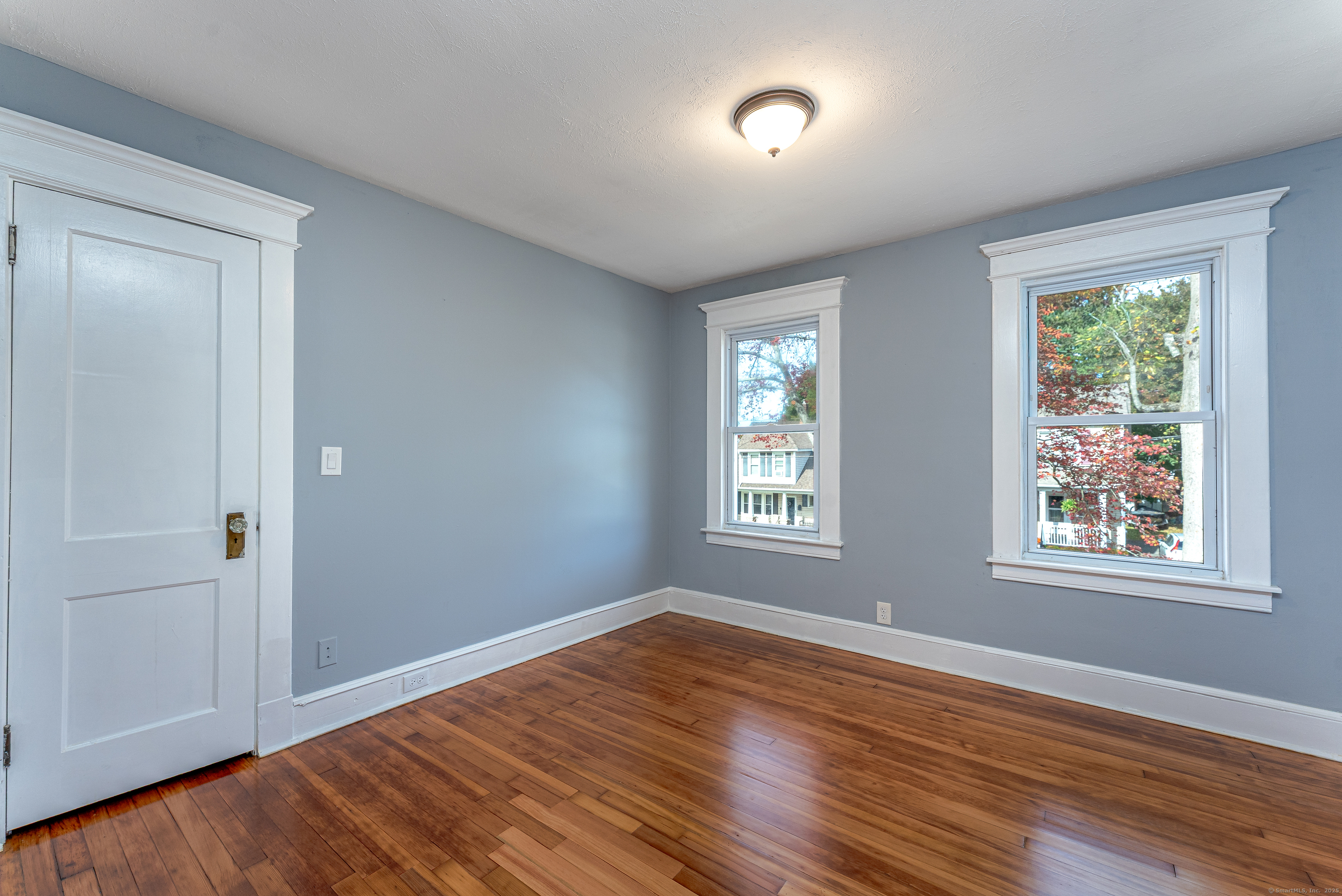 100 Ridgefield Avenue Waterbury, CT 06705 - Photo 19 of 35 an empty room with wooden floor and windows