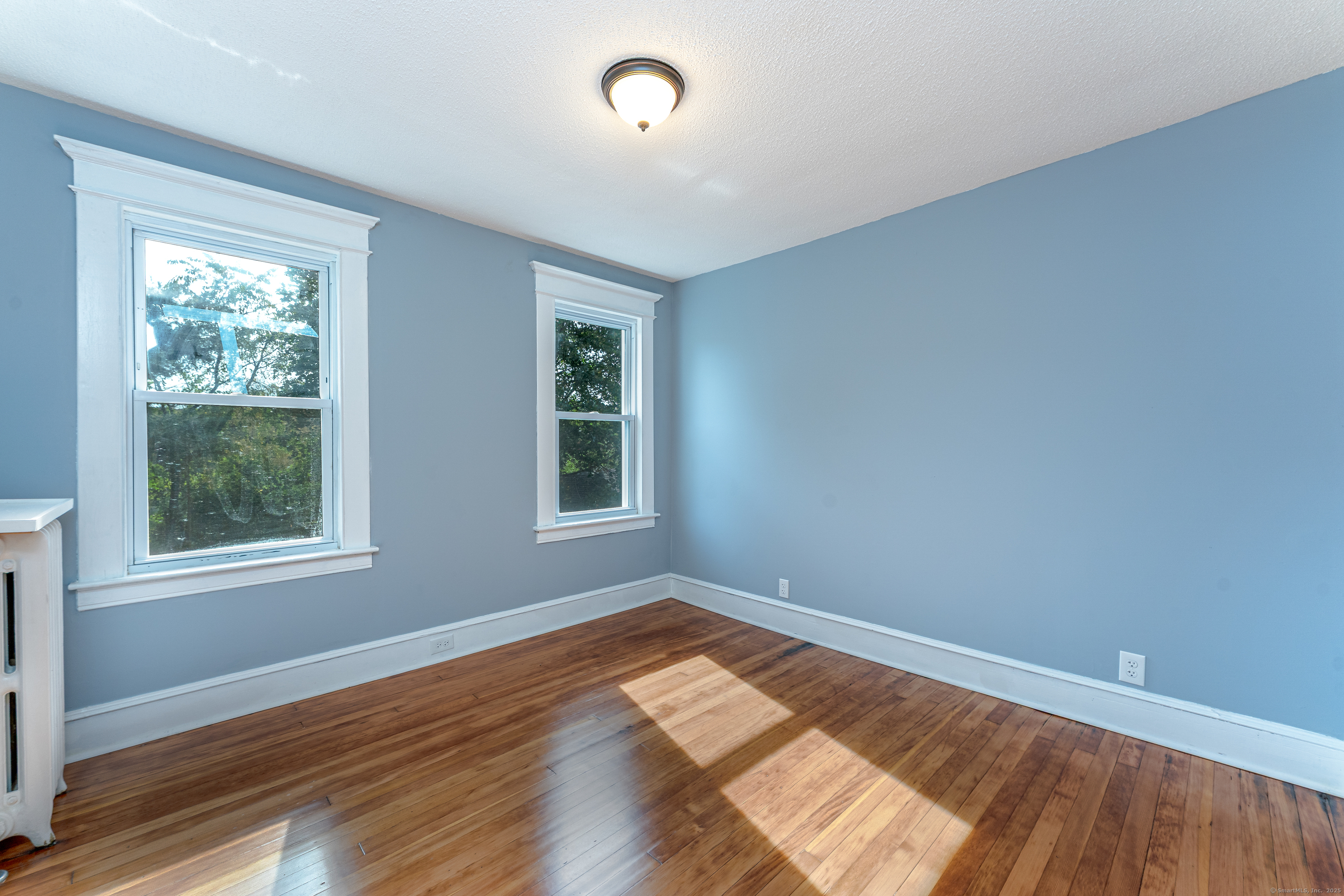 100 Ridgefield Avenue Waterbury, CT 06705 - Photo 26 of 35 a view of empty room with wooden floor and fan