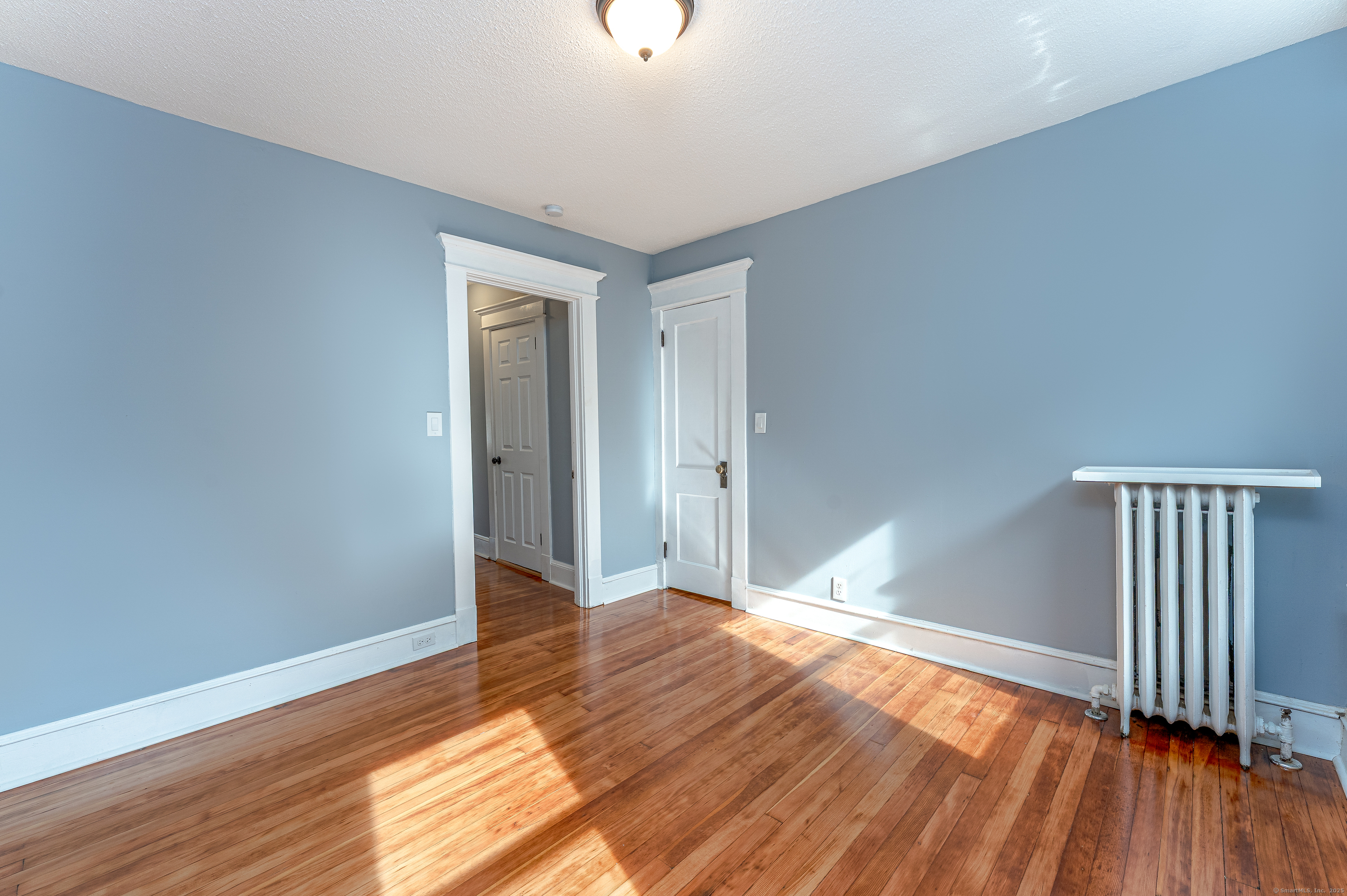 100 Ridgefield Avenue Waterbury, CT 06705 - Photo 27 of 35 a view of an empty room with wooden floor