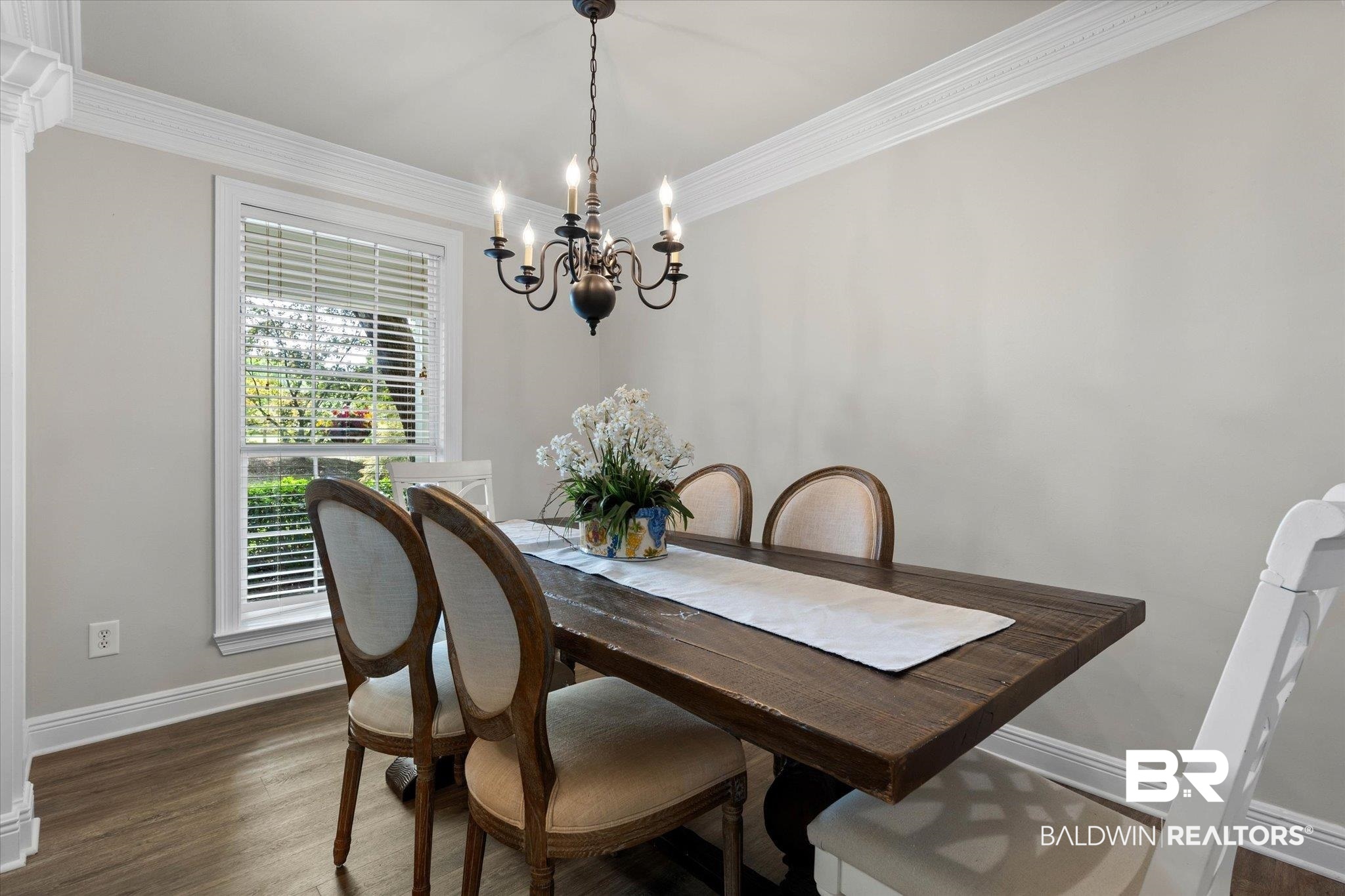 3715 Latigo Road Mobile, AL 36695 - Photo 4 of 39 Dining area with a chandelier, baseboards, dark wood-style floors, and crown molding