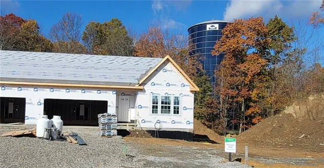 a front view of a house with outdoor seating
