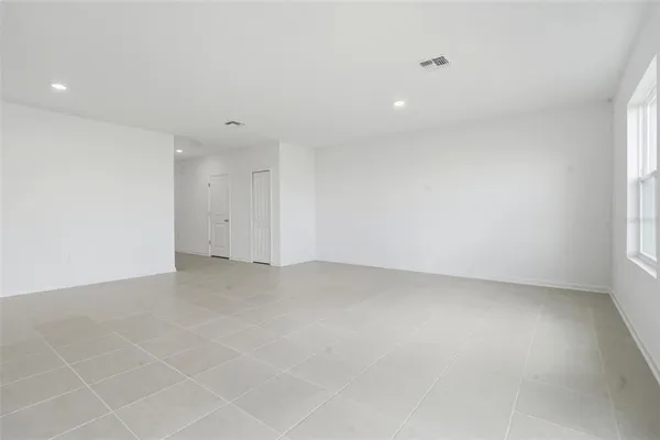 a view of a kitchen with refrigerator and chairs