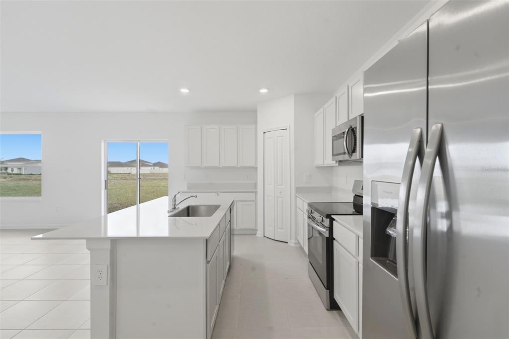2756 Lookout Rdg Road Haines City, FL 33844 - Photo 20 of 53 a kitchen with stainless steel appliances granite countertop a refrigerator and a sink