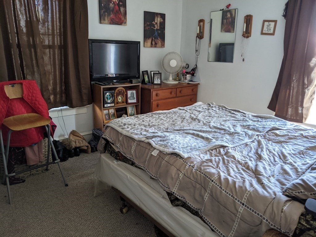 18 John Street Fall River, MA 02721 - Photo 5 of 10 a bedroom with a bed and a flat screen tv