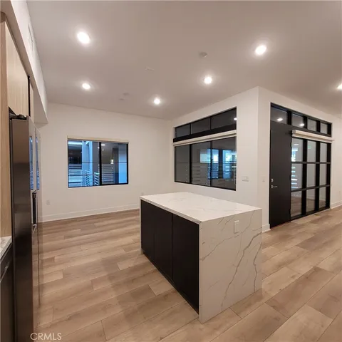 a view of kitchen with stainless steel appliances cabinets and outdoor space