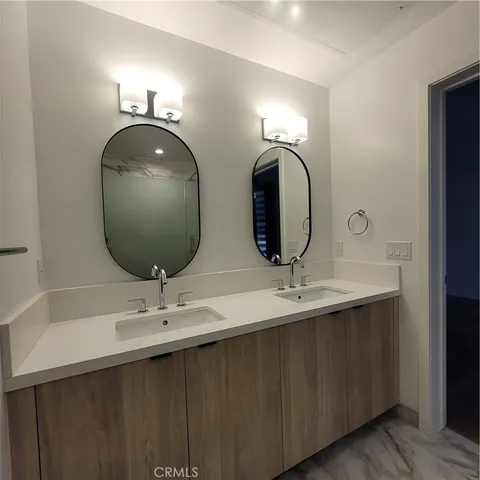 a bathroom with a double vanity sink and a mirror