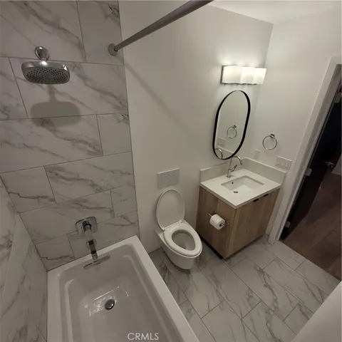a bathroom with a sink a toilet and bathtub