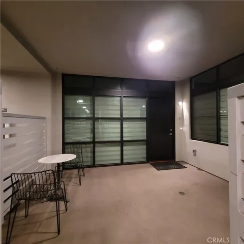 a view of bedroom with window and cabinet