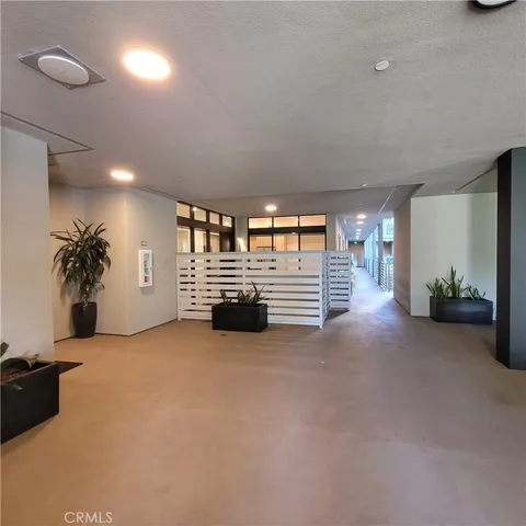 a lobby with furniture and potted plant