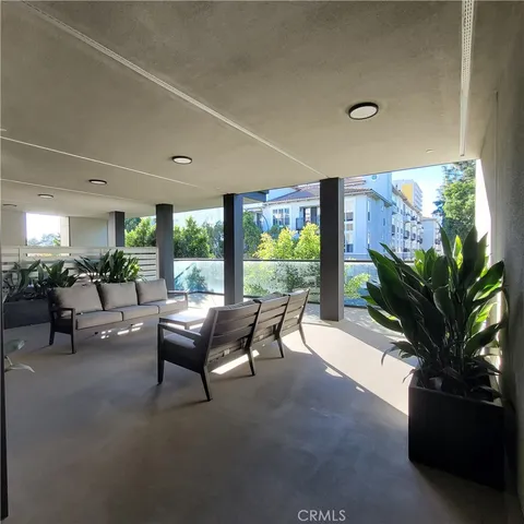 a living room with furniture and a view of kitchen