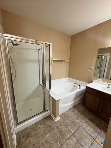 a bathroom with a tub and shower