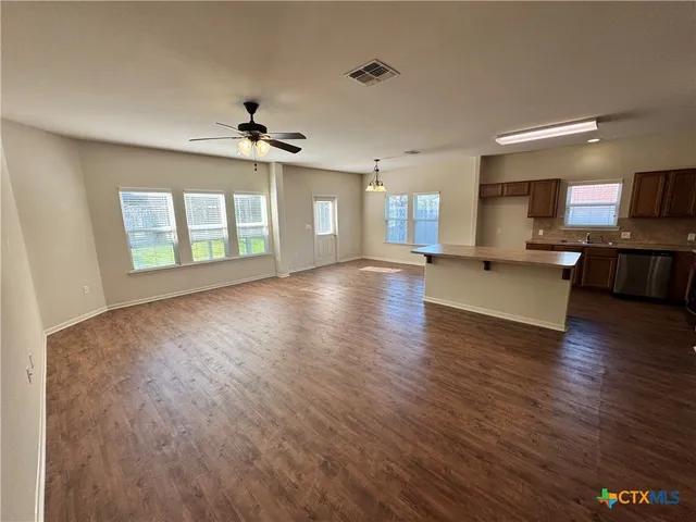 a view of a kitchen with a stove cabinets and wooden floor