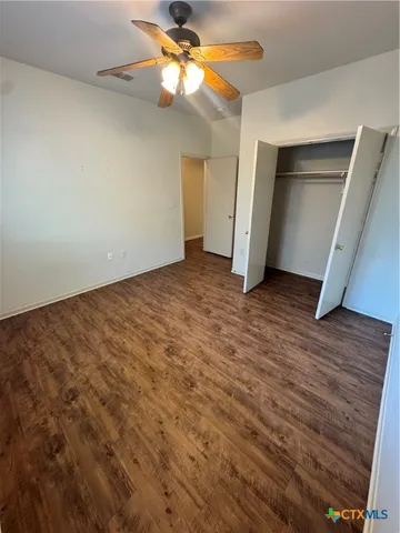 an empty room with a empty space and a ceiling fan