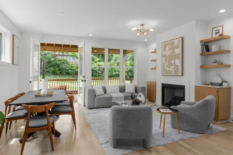 a bathroom with a granite countertop sink a toilet and a mirror