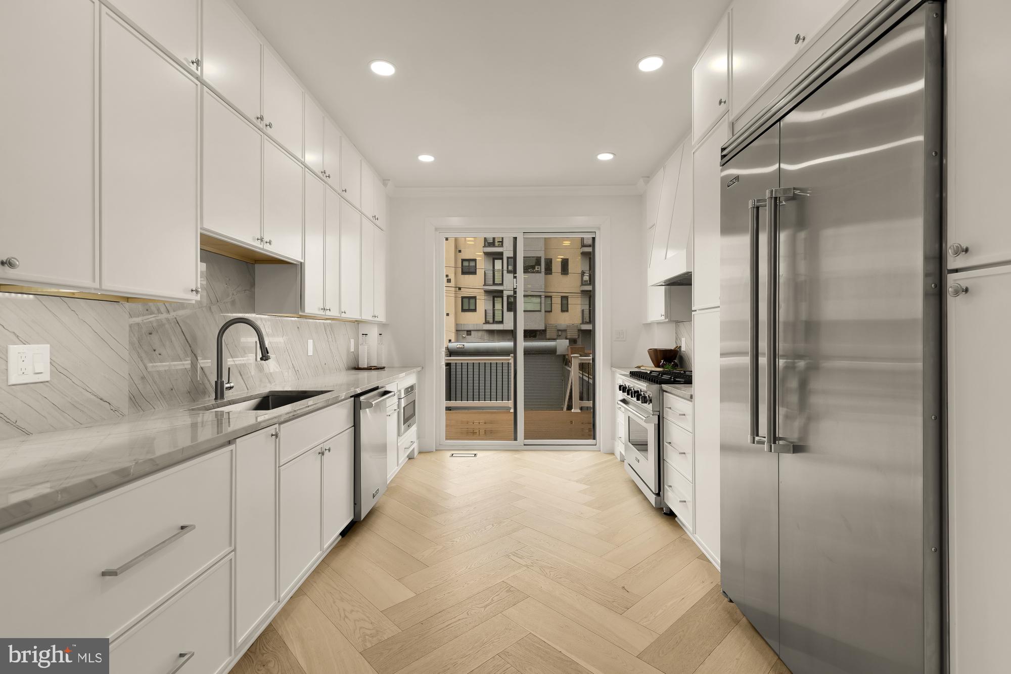 1932 11th Street Northwest Washington, DC 20001 - Photo 15 of 53 a kitchen with stainless steel appliances granite countertop a refrigerator and a sink
