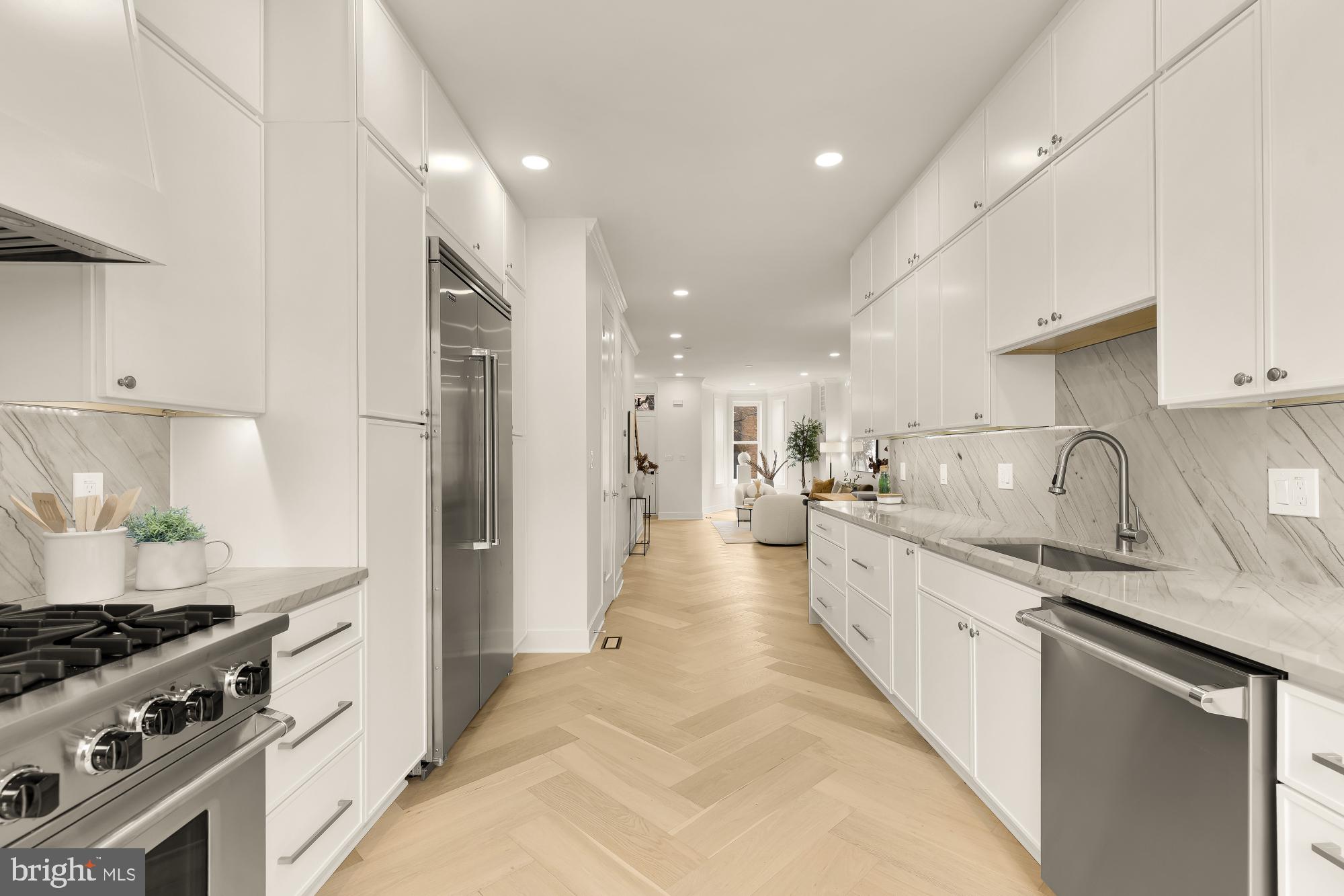 1932 11th Street Northwest Washington, DC 20001 - Photo 19 of 53 a large kitchen with stainless steel appliances granite countertop a lot of counter space and wooden floors