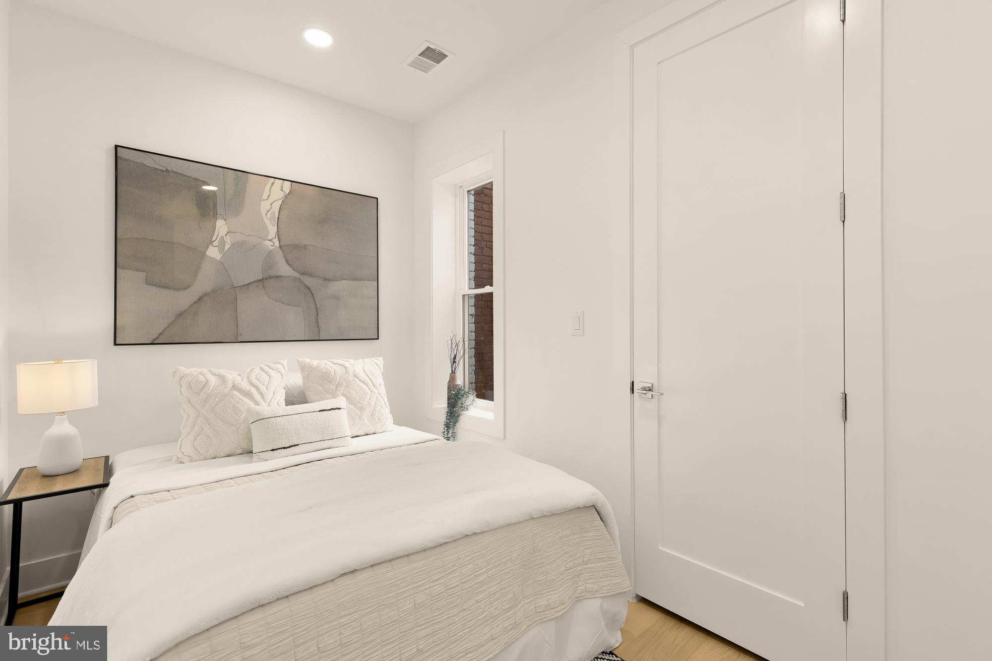 1932 11th Street Northwest Washington, DC 20001 - Photo 23 of 53 a bedroom with a bed and a painting on the wall