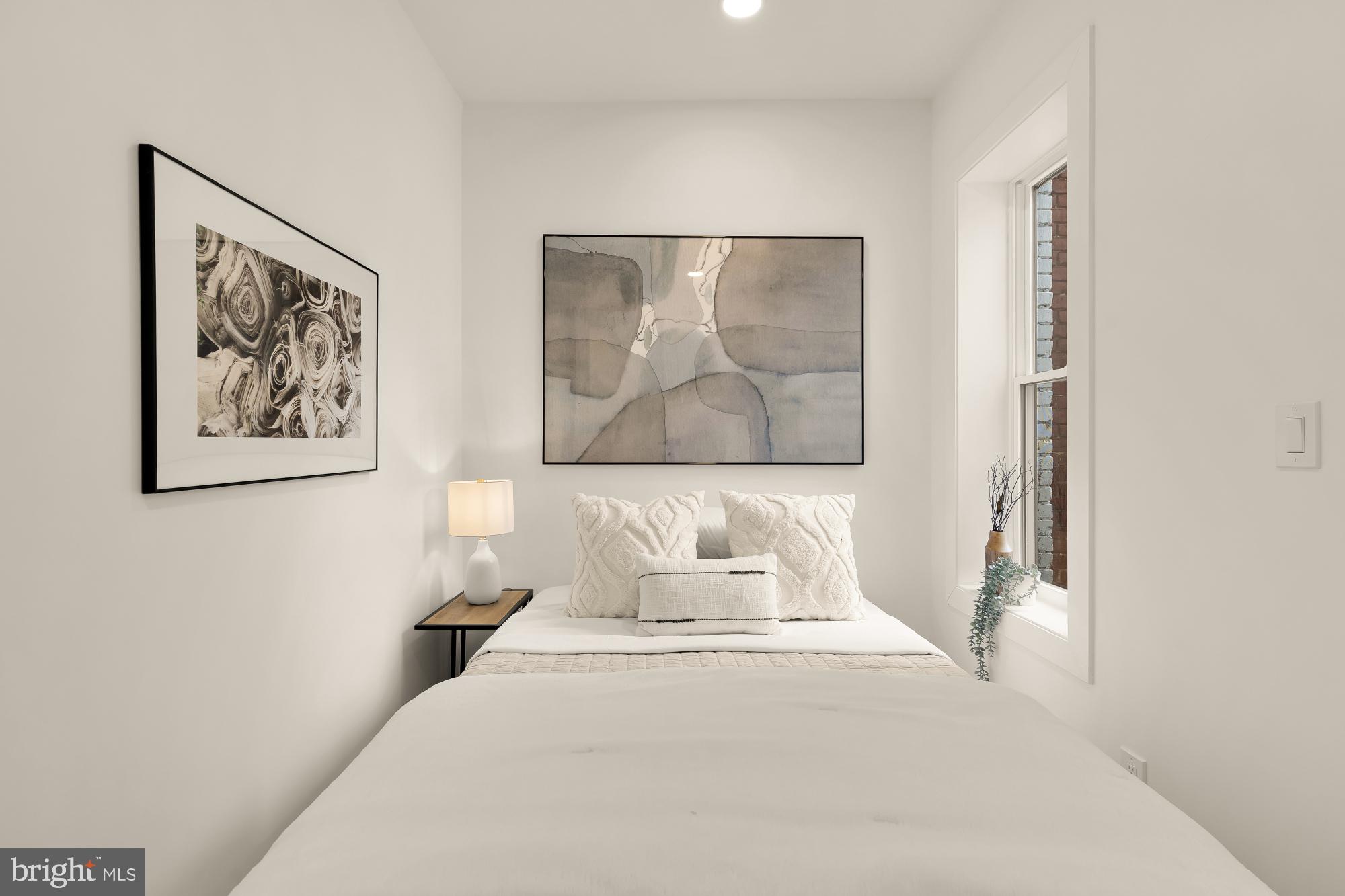 1932 11th Street Northwest Washington, DC 20001 - Photo 24 of 53 a bedroom with a large bed and a painting on the wall