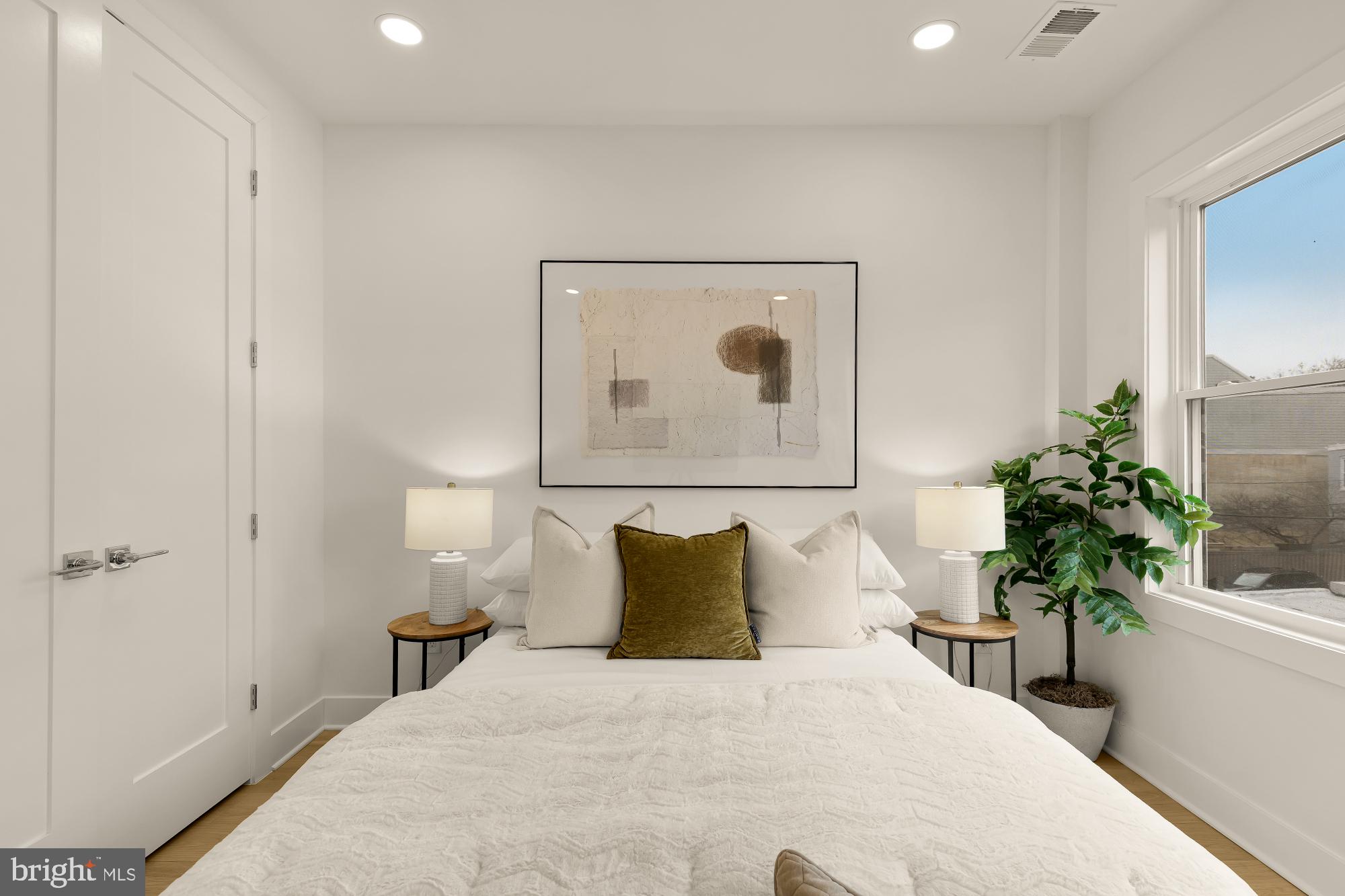 1932 11th Street Northwest Washington, DC 20001 - Photo 27 of 53 a bedroom with a bed and a potted plant