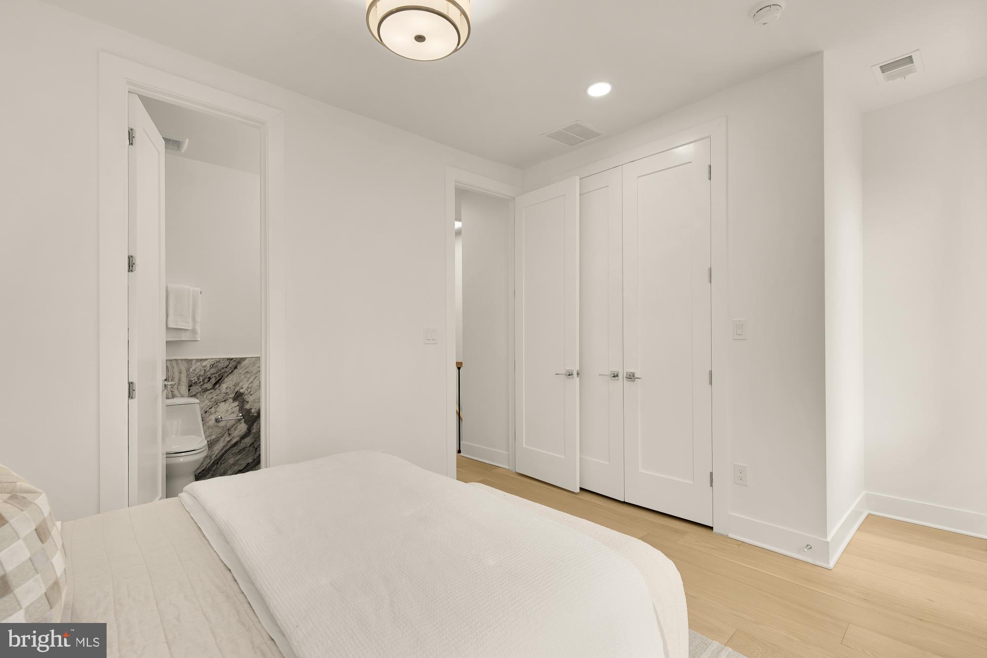 1932 11th Street Northwest Washington, DC 20001 - Photo 32 of 53 a bedroom with a bed and a mirror