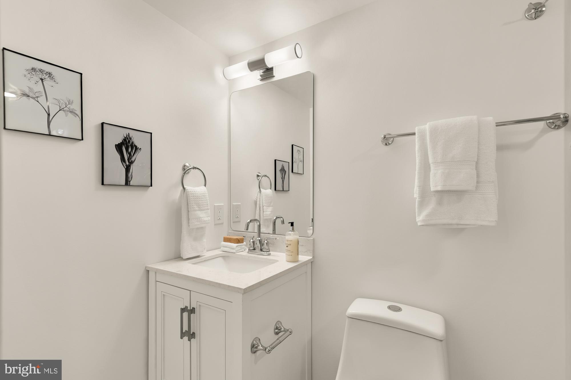 1932 11th Street Northwest Washington, DC 20001 - Photo 43 of 53 a bathroom with a sink a toilet and mirror