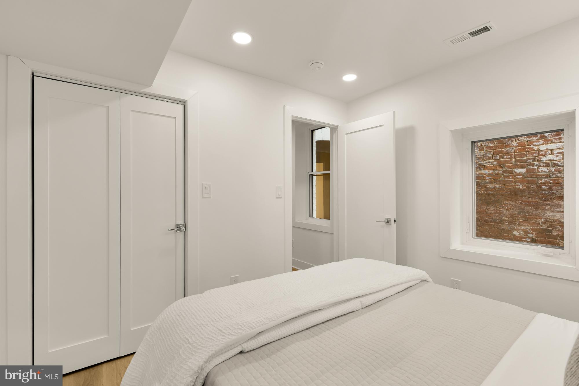 1932 11th Street Northwest Washington, DC 20001 - Photo 46 of 53 a bedroom with a bed and a window