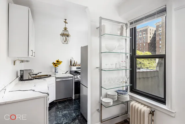 a view of an empty room and dining room