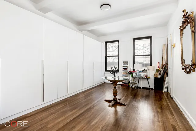 a view of a hallway to closet and wooden floor