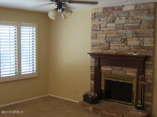 3318 East Desert Trumpet Road Phoenix, AZ 85044 - Photo 9 of 22 family_room_fireplace
