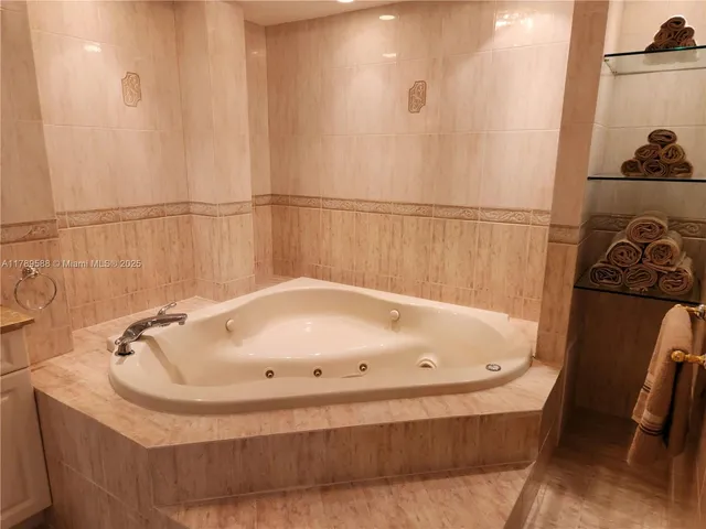 a bathroom with a tub and a shower