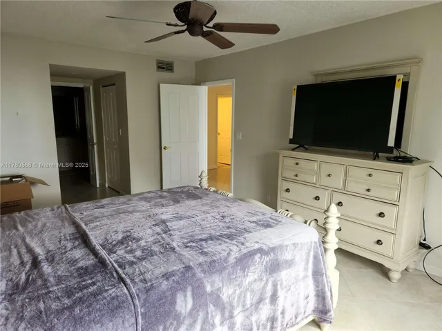 a bedroom with a bed and a flat screen tv in it