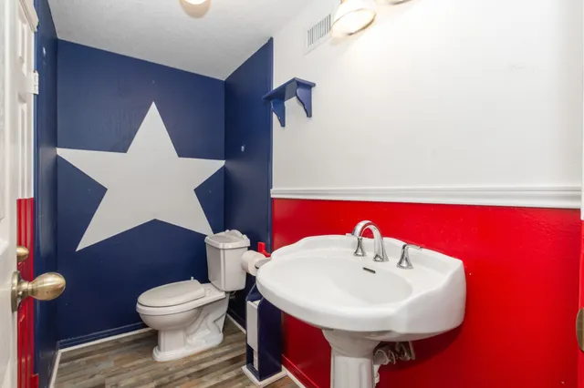 a bathroom with a sink a toilet and mirror