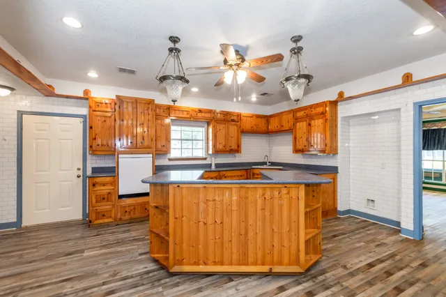 a kitchen with stainless steel appliances granite countertop a sink and a refrigerator