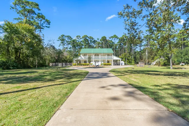 a view of swimming pool that has lawn chairs and a lawn chairs
