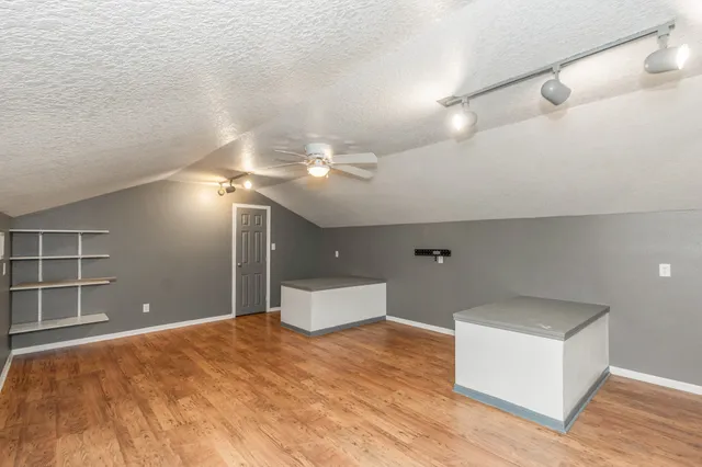 a view of a livingroom with a ceiling fan and wooden floor
