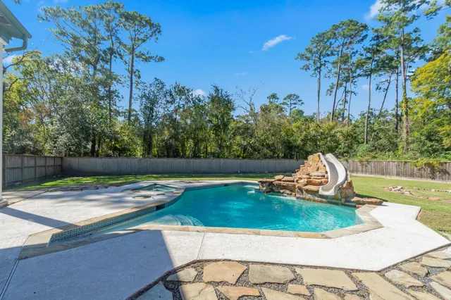 a view of a house with a yard and potted plants