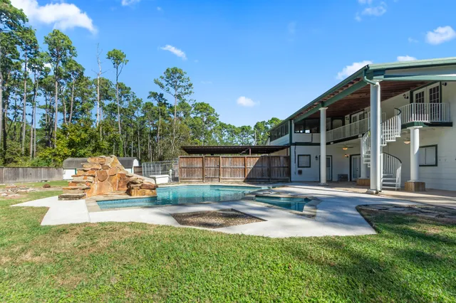 an aerial view of a house with a swimming pool