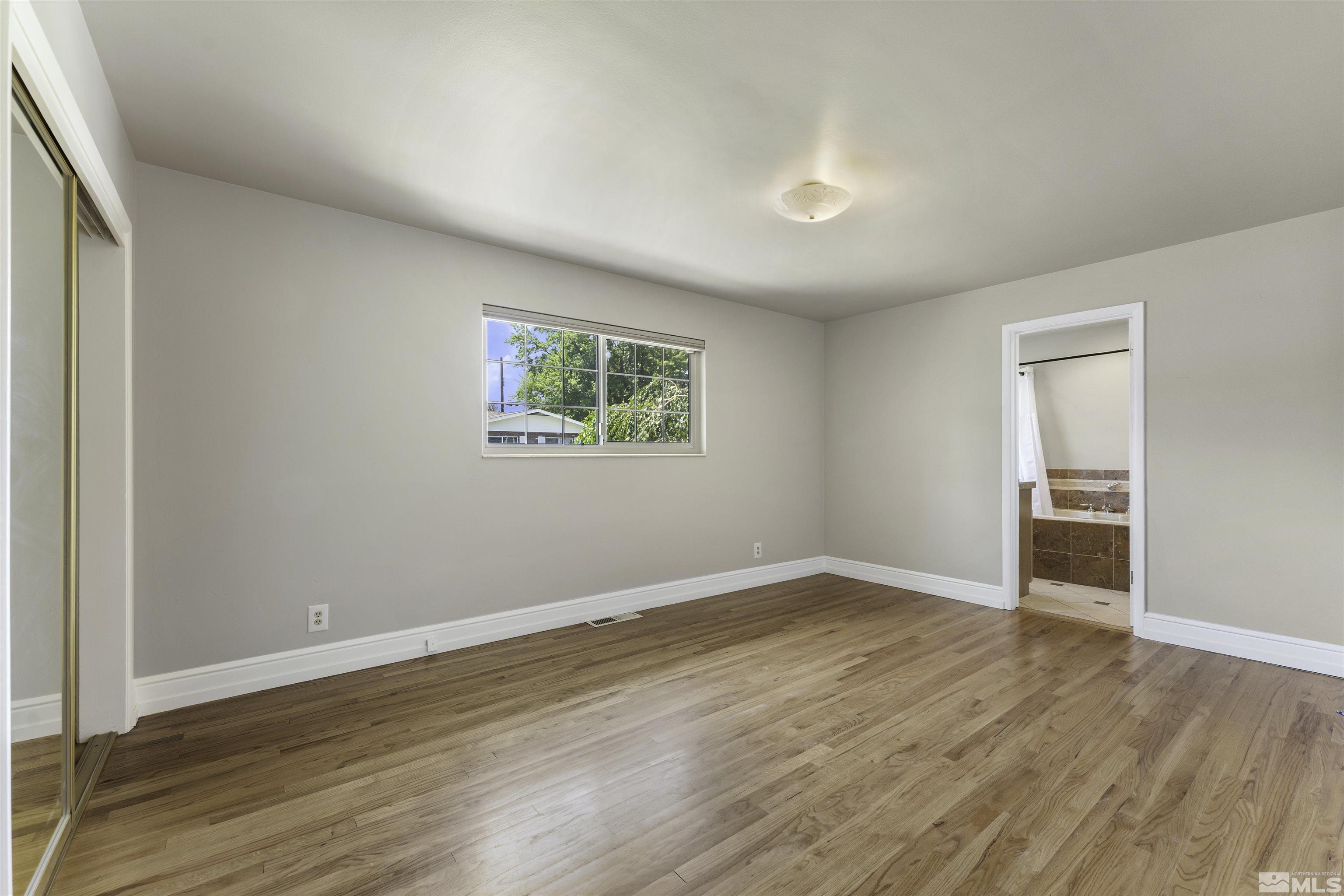 1401 Romero Way Reno, NV 89509 - Photo 16 of 28 an empty room with wooden floor and windows