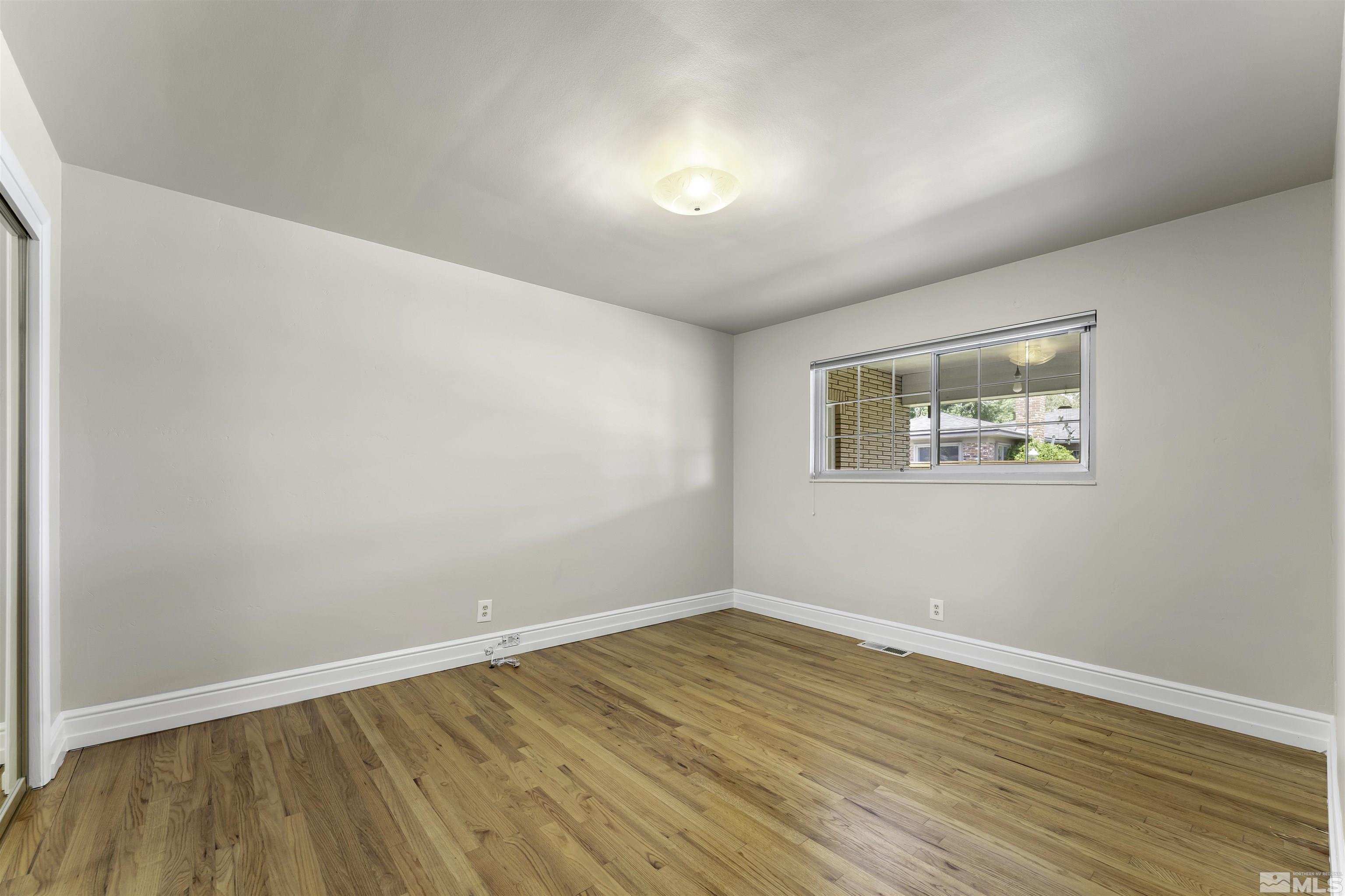 1401 Romero Way Reno, NV 89509 - Photo 19 of 28 a view of empty room with wooden floor and fan