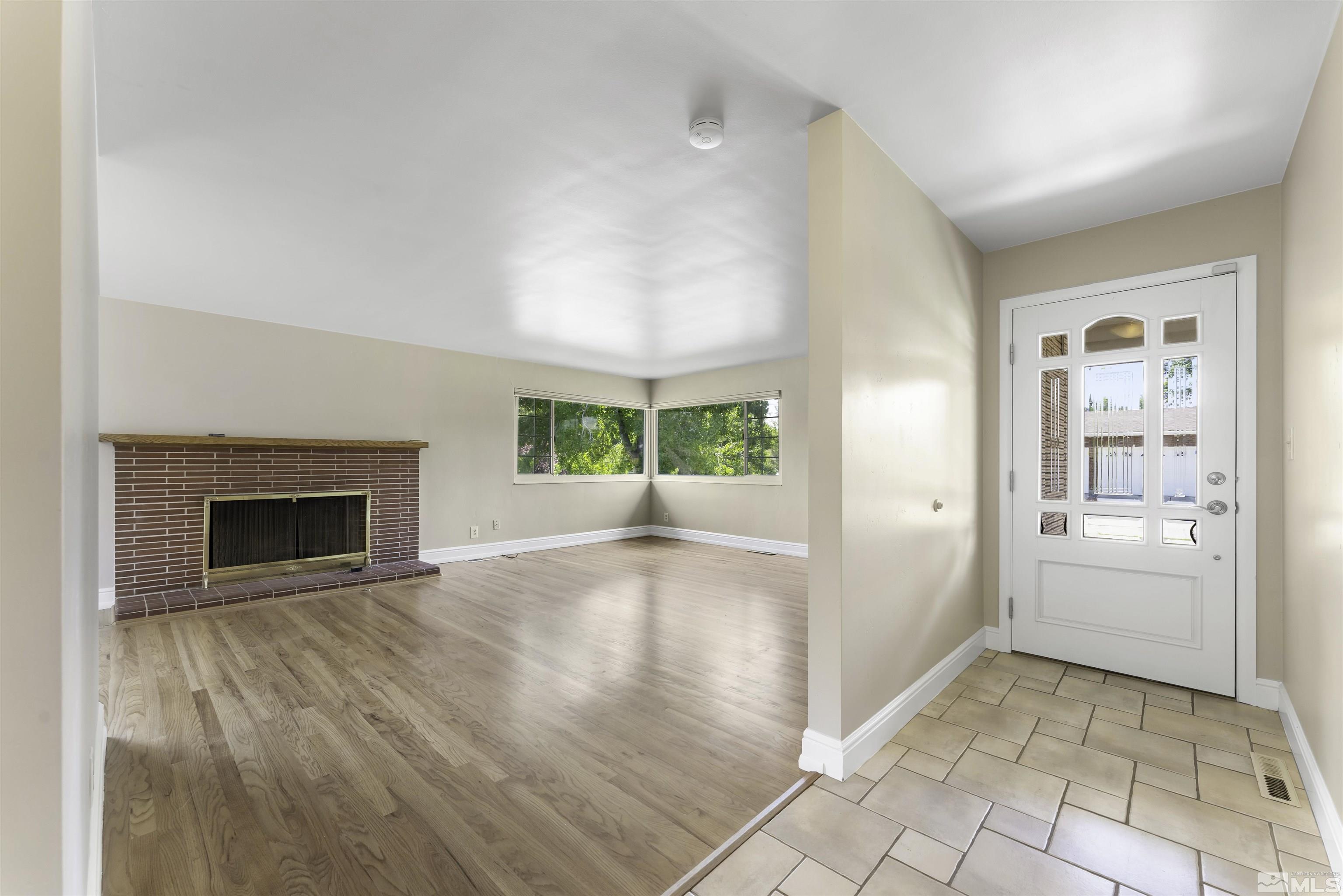 1401 Romero Way Reno, NV 89509 - Photo 6 of 28 a view of empty room with a fireplace and wooden floor
