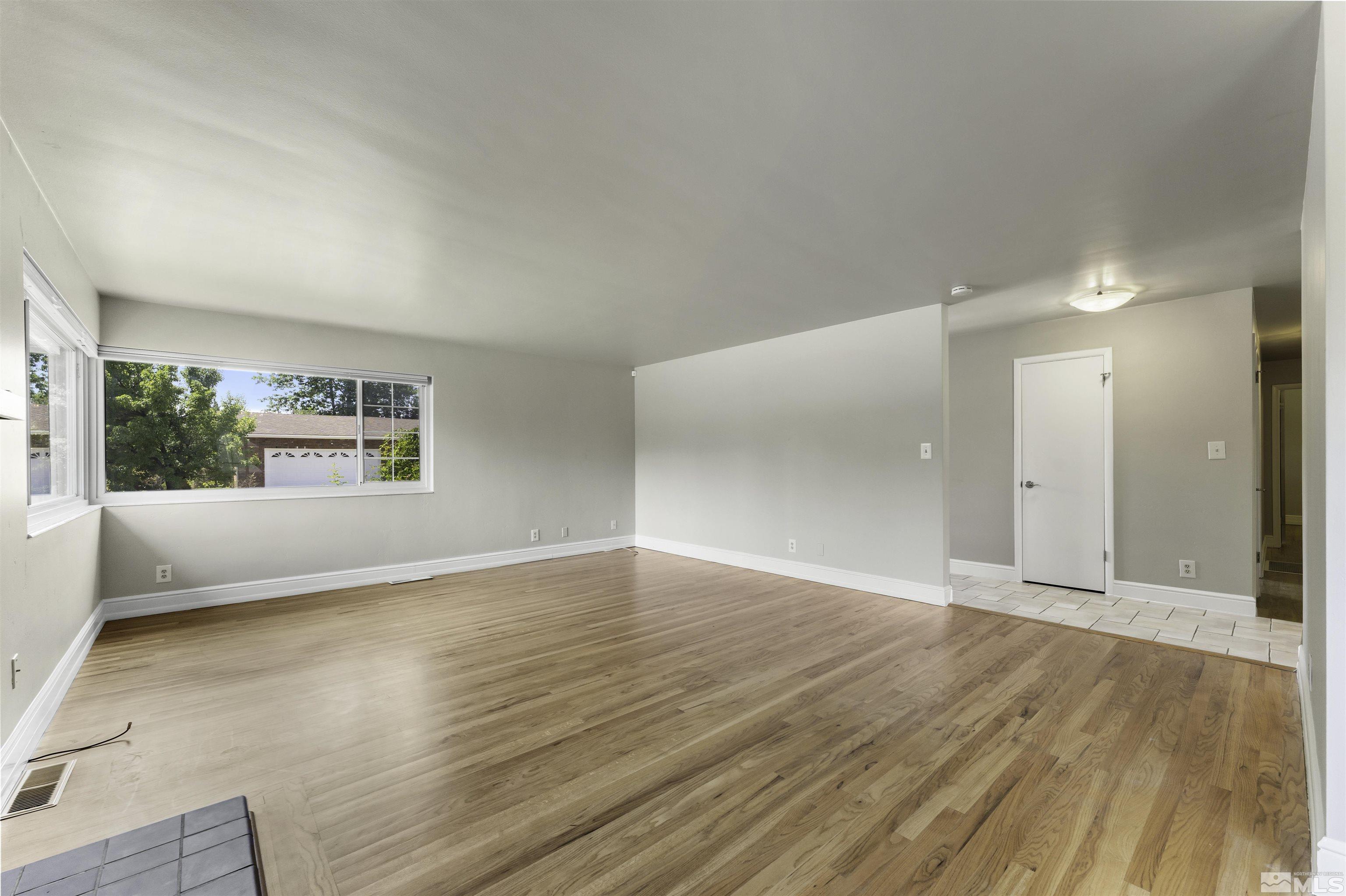 1401 Romero Way Reno, NV 89509 - Photo 8 of 28 an empty room with wooden floor and windows