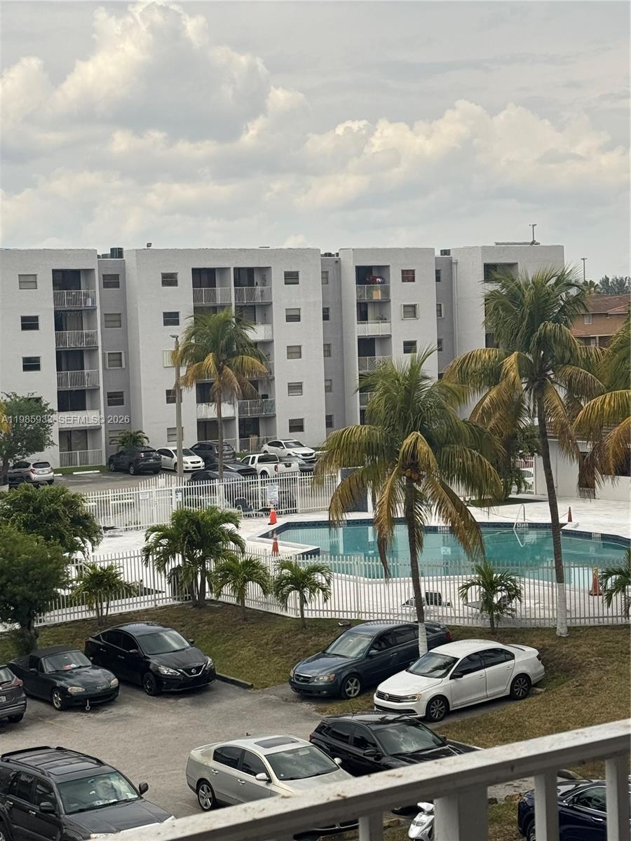 8075 Northwest 7th Street, Unit 403 Miami, FL 33126 - Photo 13 of 29 a cars parked in front of a building